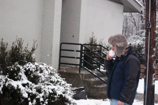 John Spade eats a snowball.