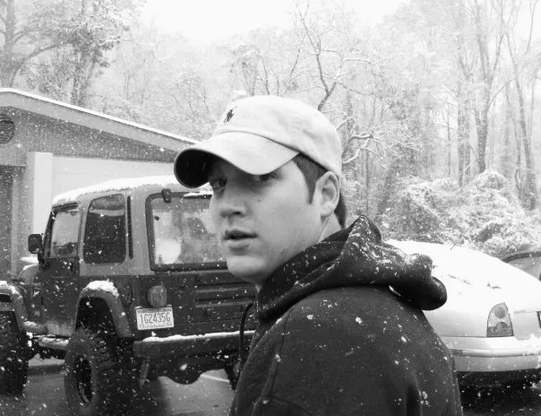 An uncomfortably close shot of Chad in the fraternity house parking lot.