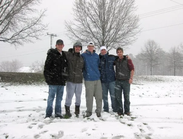 Friends pose in the snow.