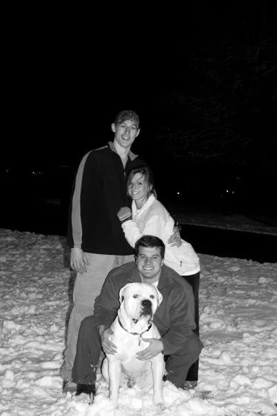 Jordan, Kelsey, Mackey and Tyson the dog pose for a picture in the snow.