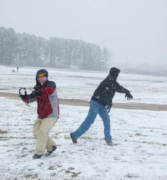 Andrew winds up to throw a snowball.
