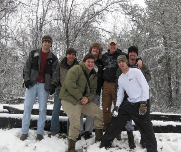 Friends pose for a picture in the snow.