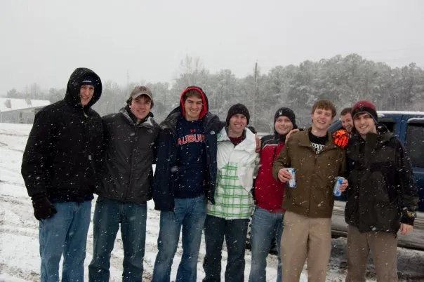 Friends pose for a picture in the snow.
