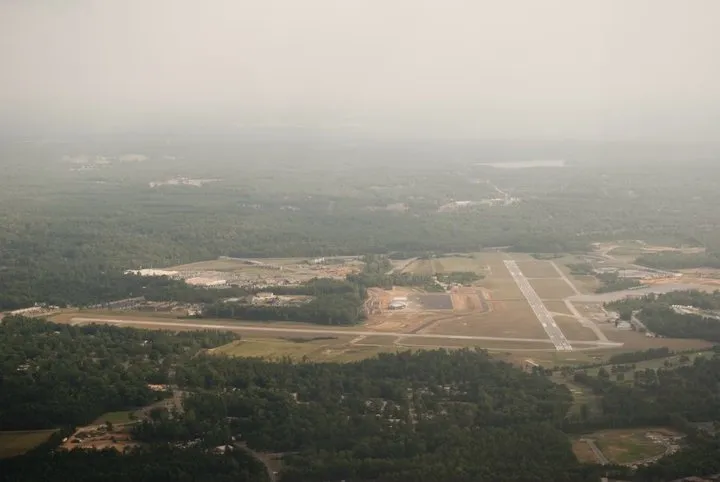 View of airport in the distance from a plane.