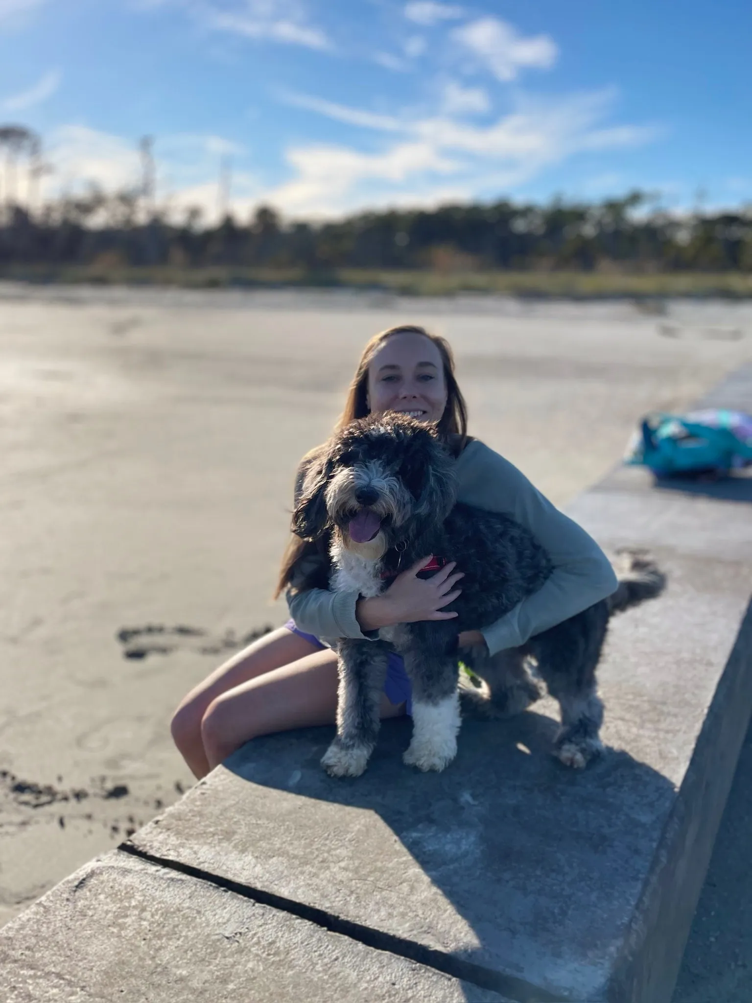 Holly hugs Otto on a wall at Hunting Island.