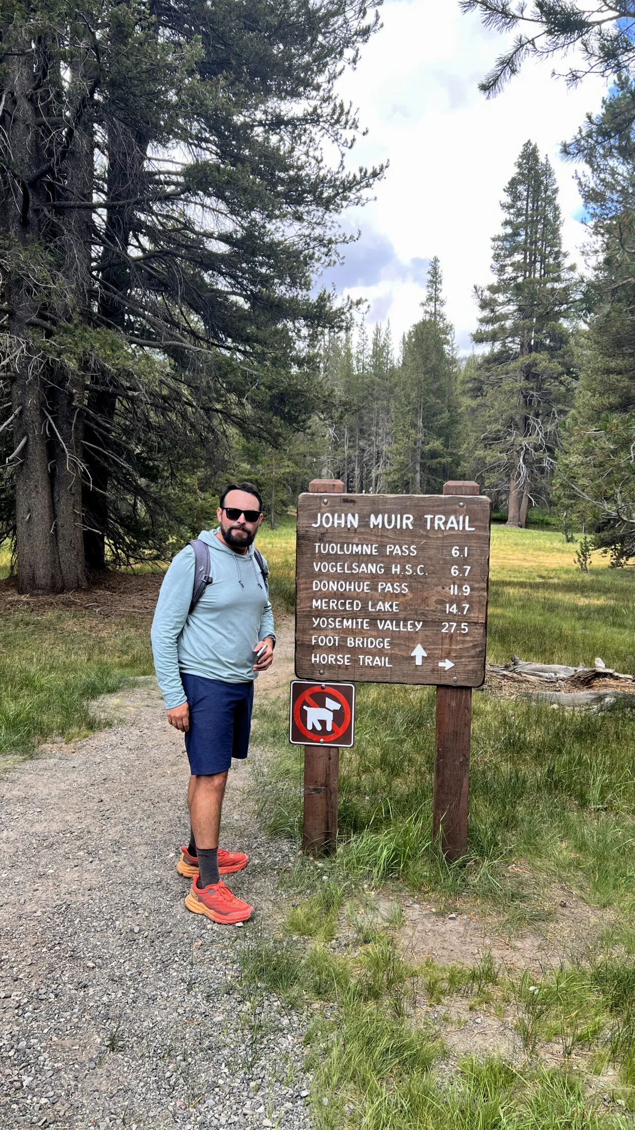 Sam Solomon standing in front of the John Muir trailhead near Tuolumne Meadows. 