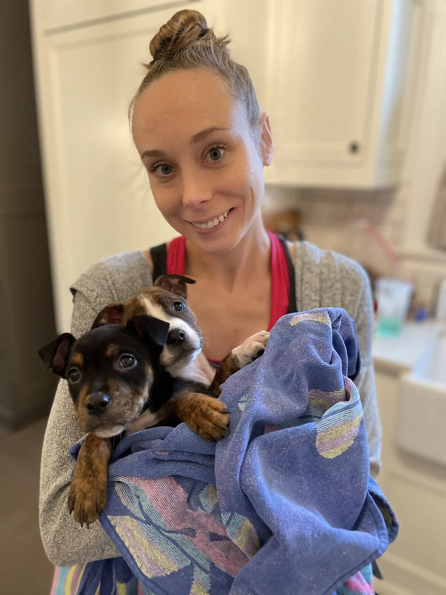 Holly holds Mangia and Munchie with a towel.