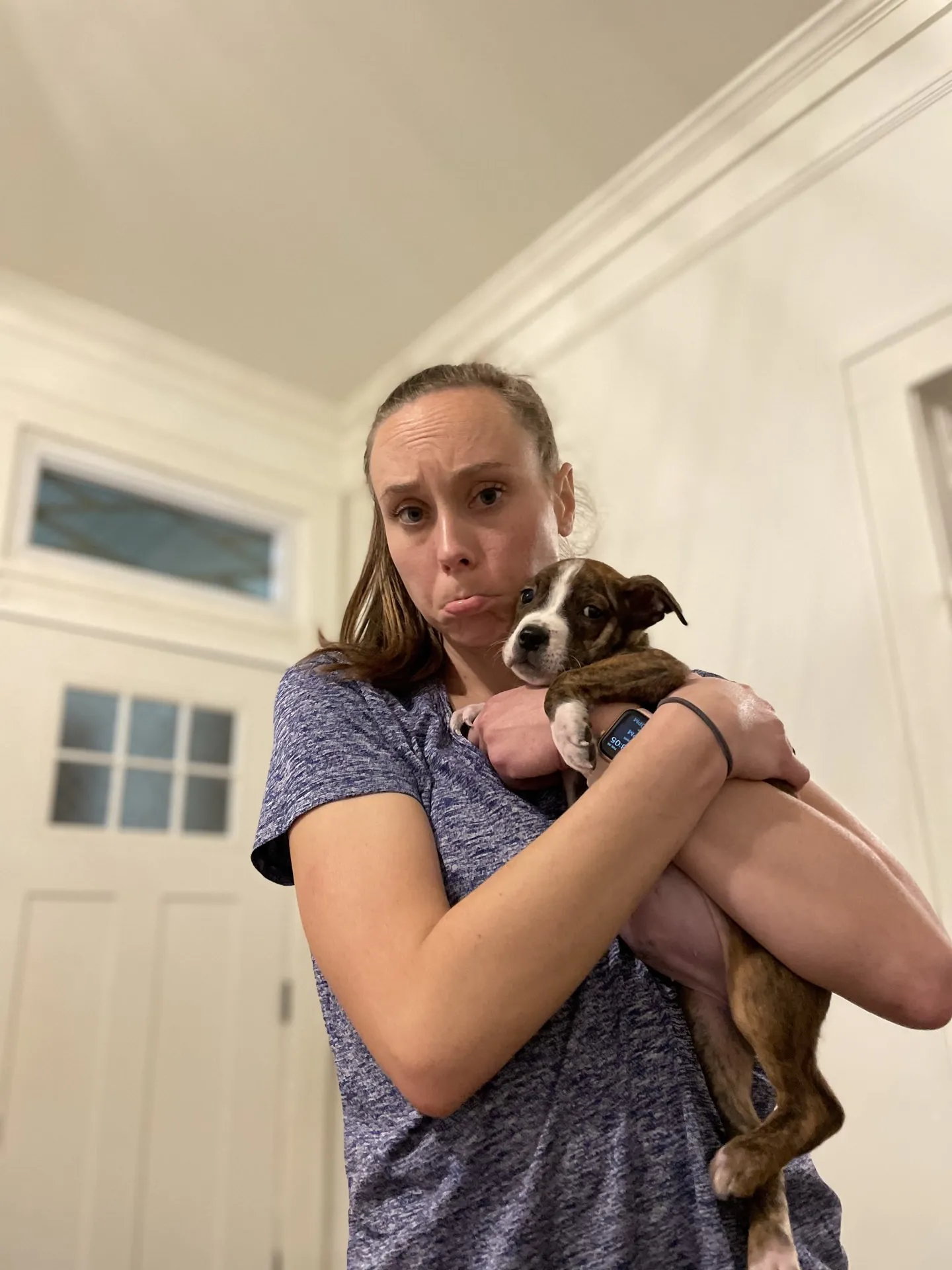 Holly makes a sad face and hugs Munchie.