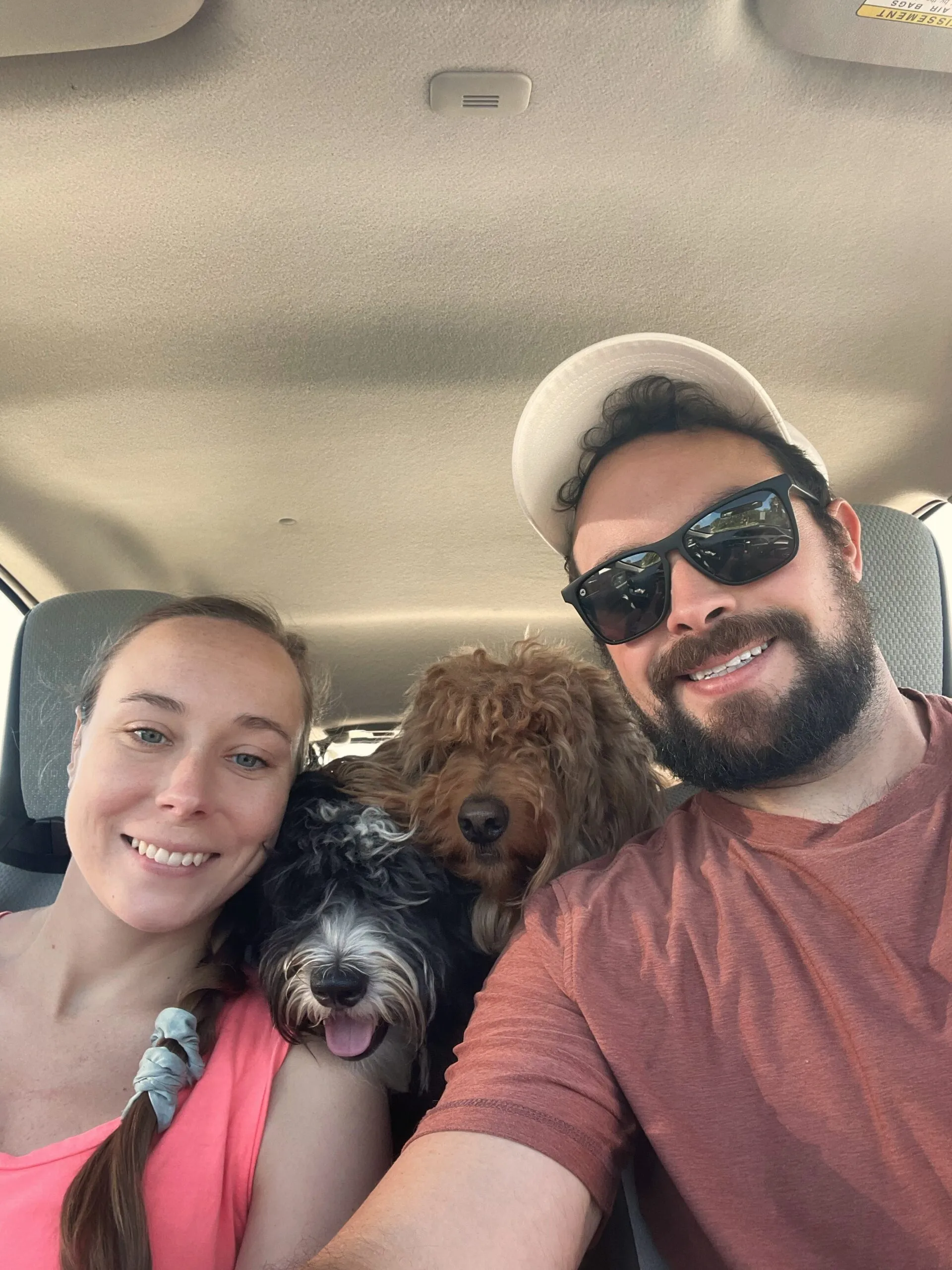 Holly, Remi and Sam in the car smiling.