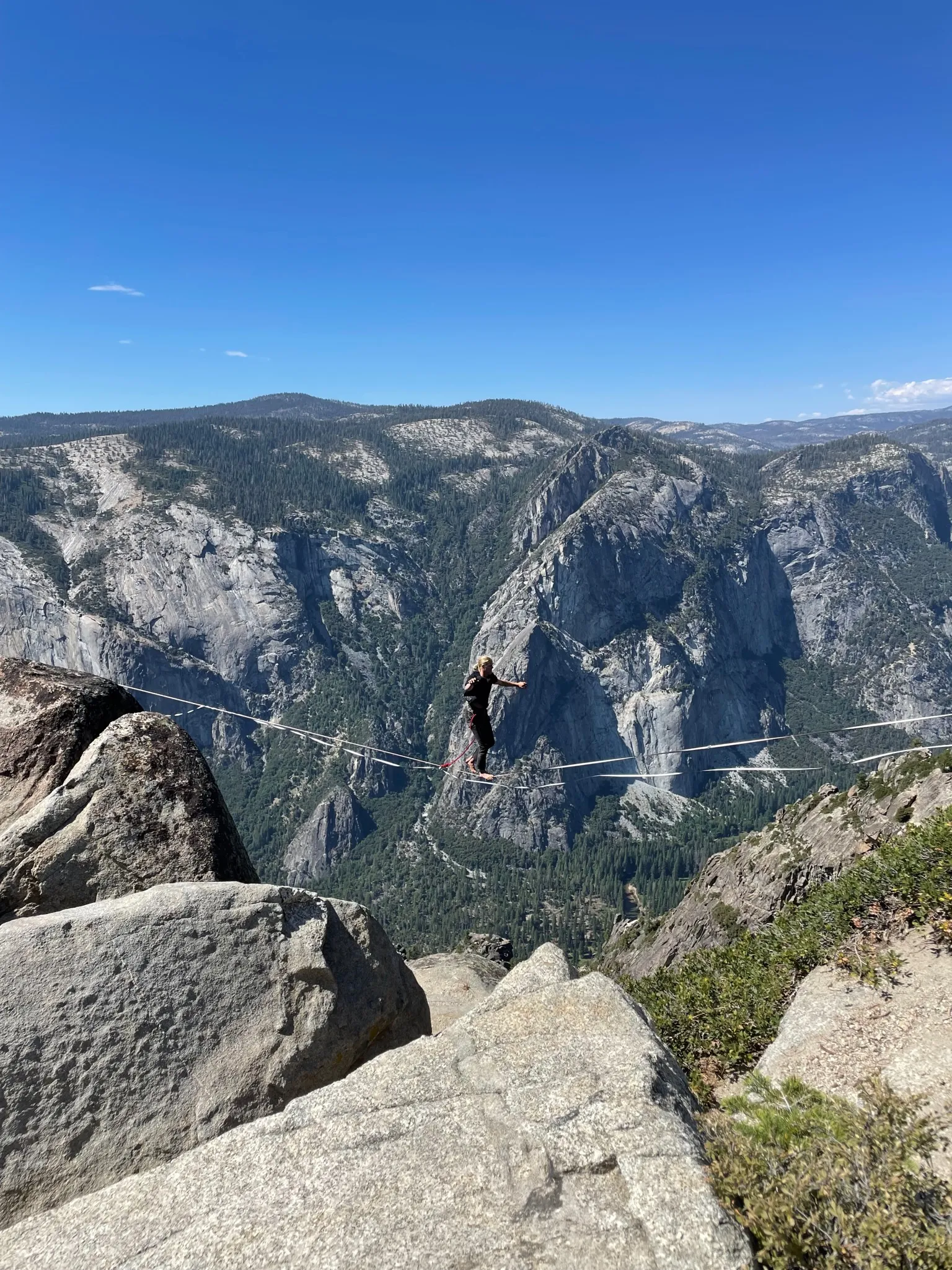 A slackliner walks a rope at Taft Point.