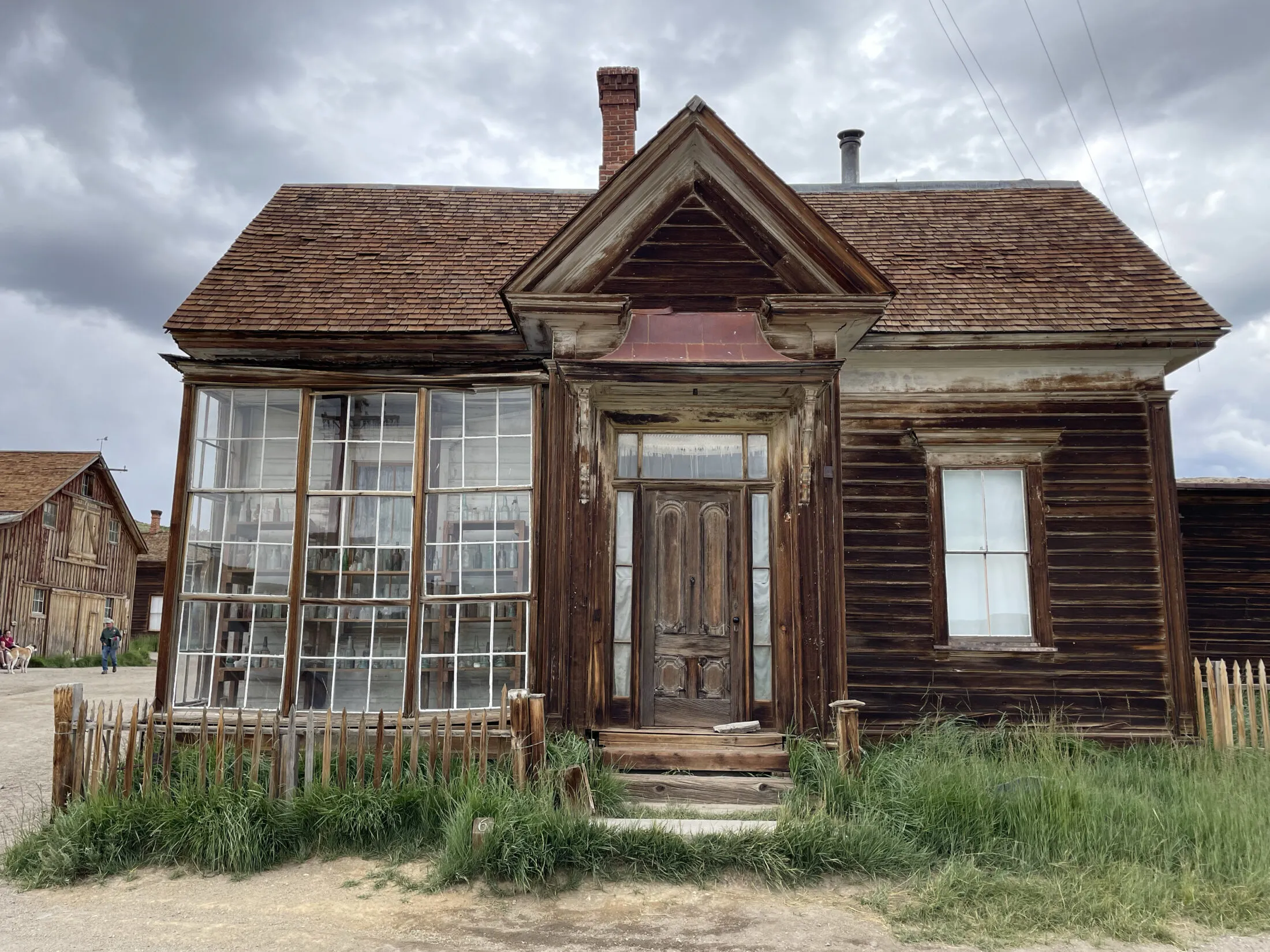 An old pharmacy with large glass windows.