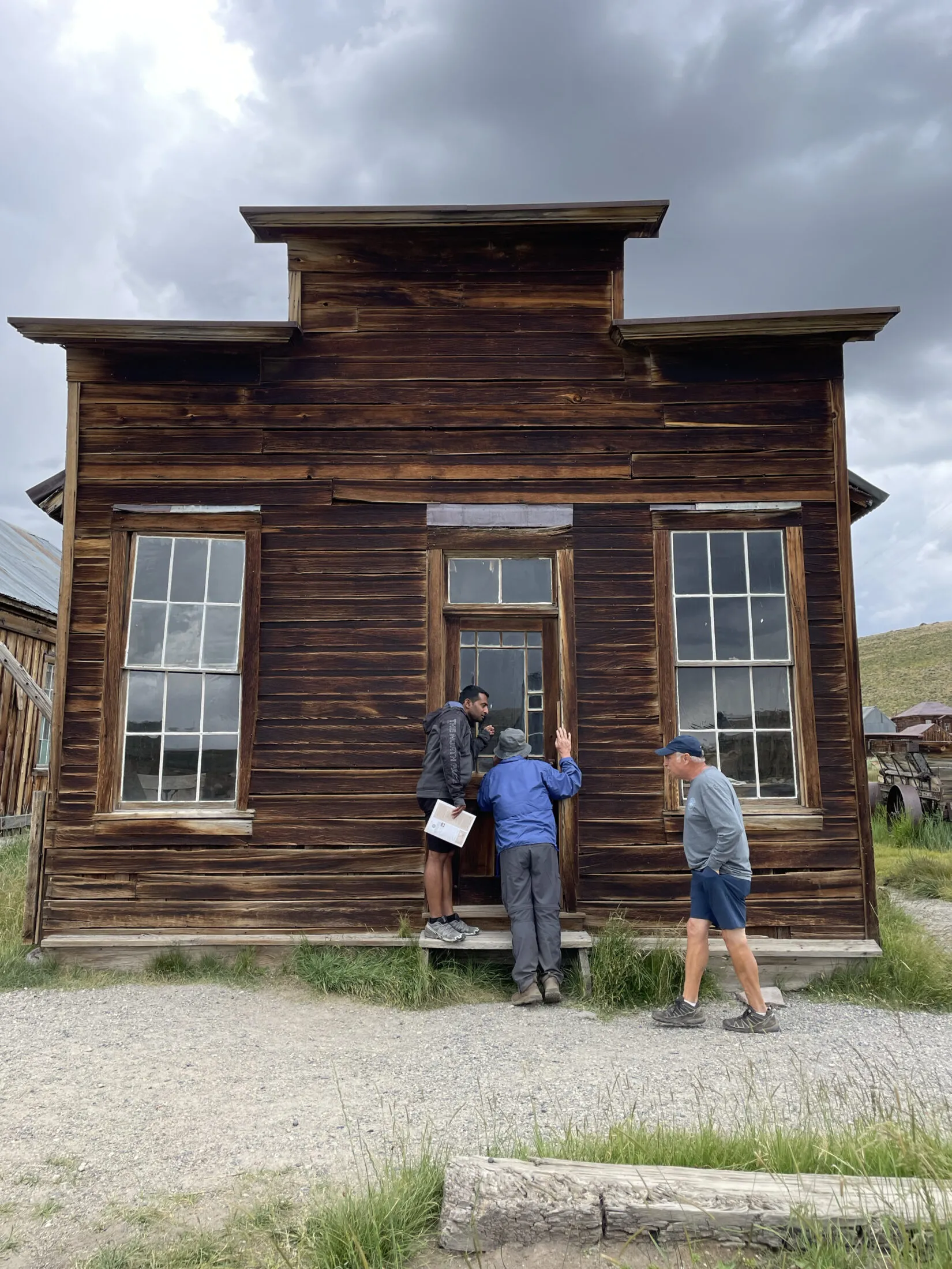 Andi and Unce Ron looking through the glass door of an old building.