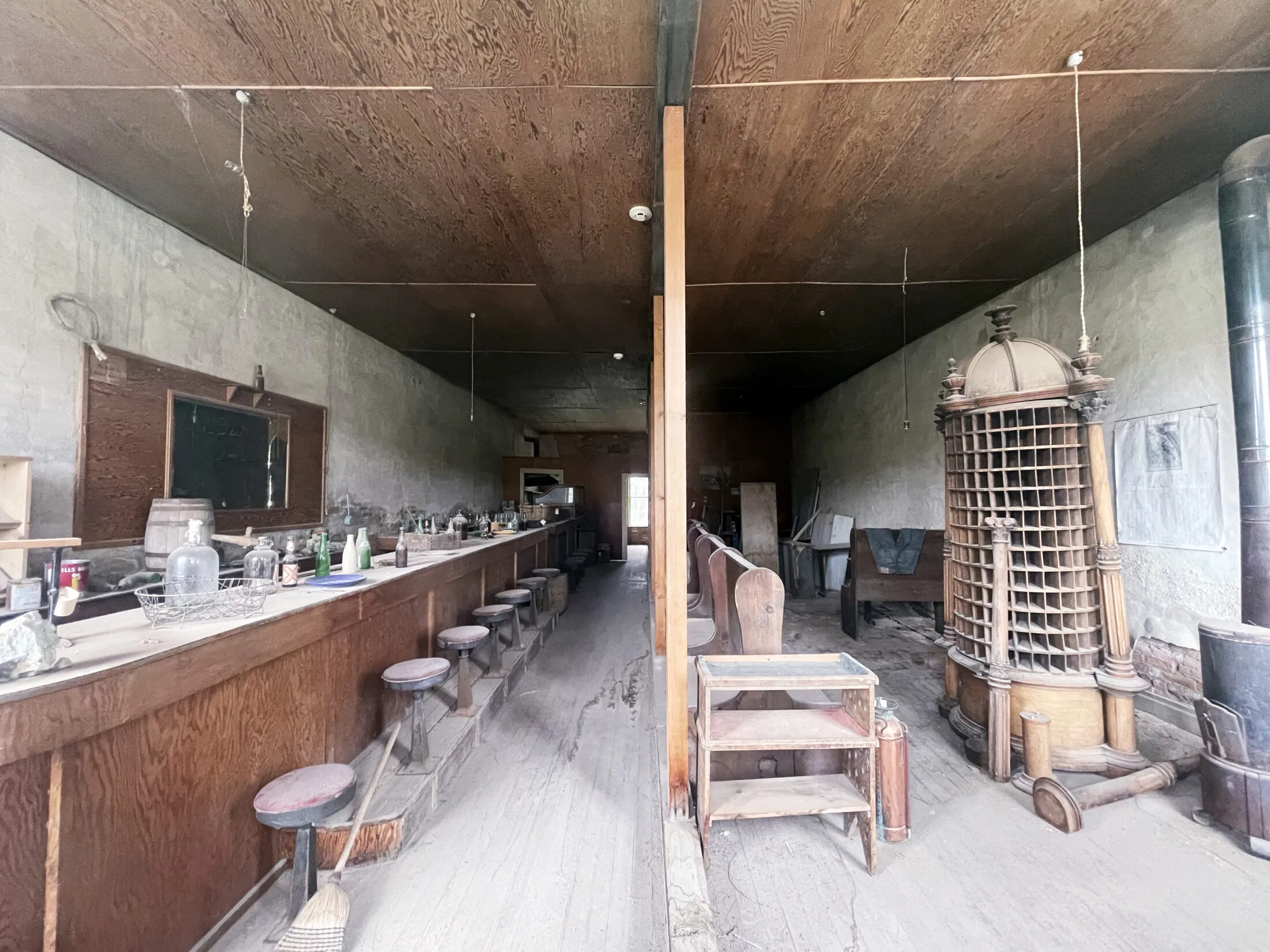 A bar to the left with old mail slots to the right.