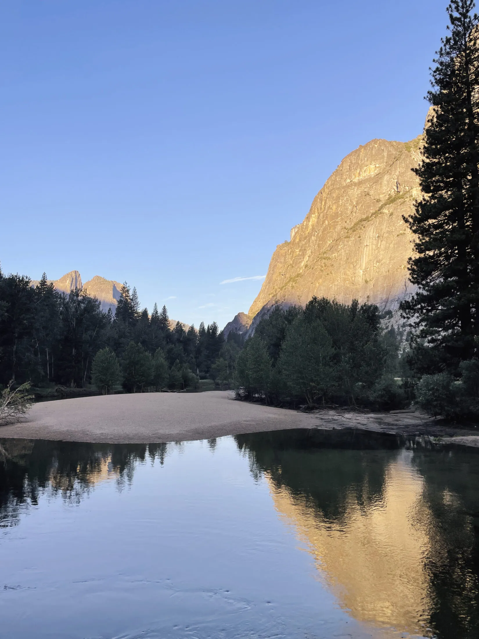Light hits the face of a mountain.