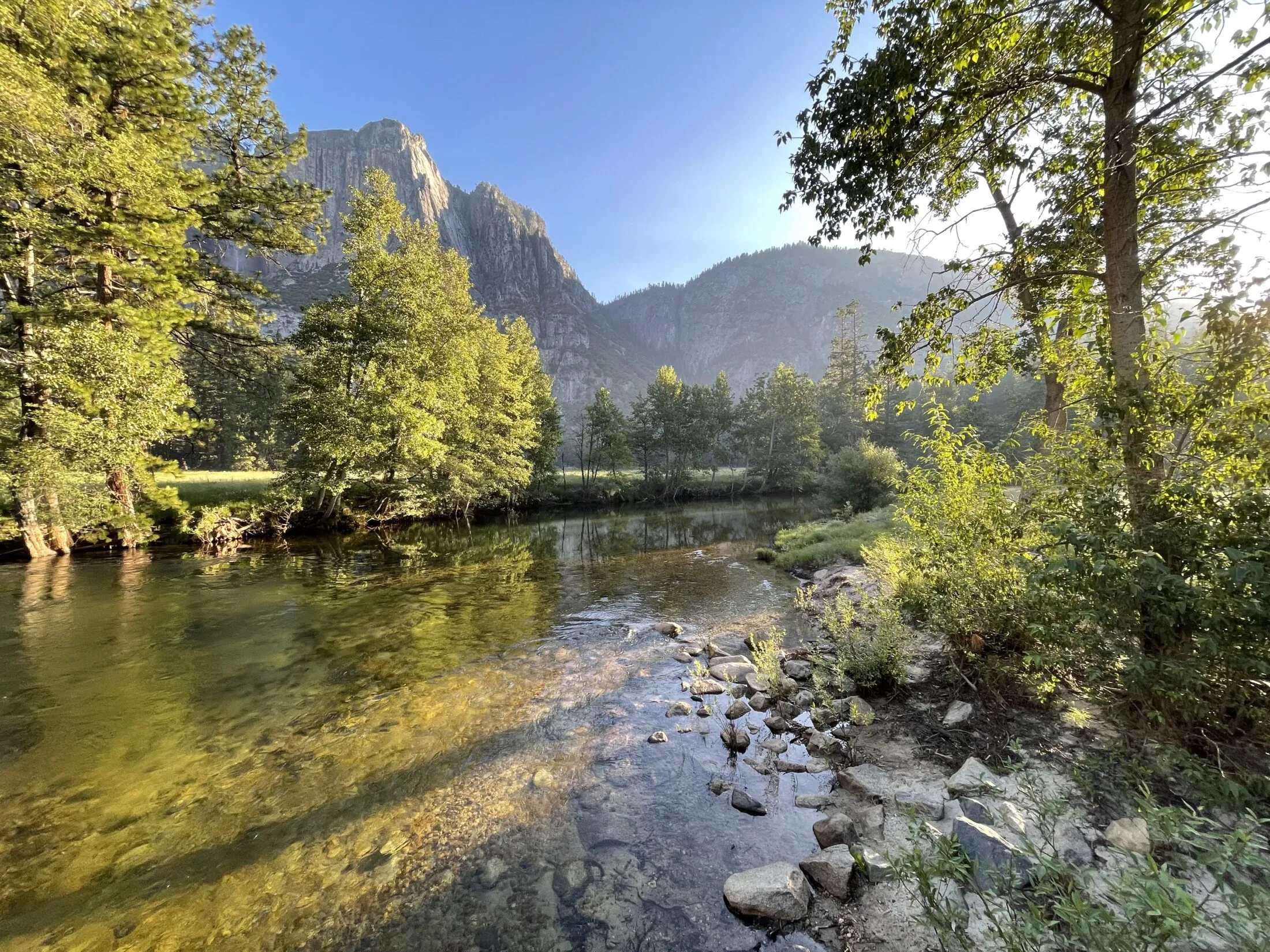 Light coming over the mountains onto the river.