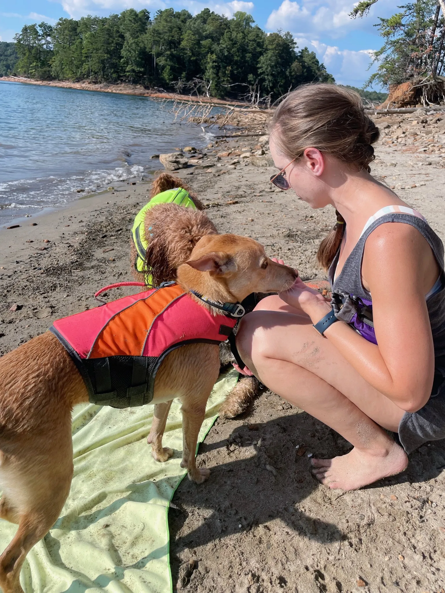 Holly squats down in front of Luna and Remi.