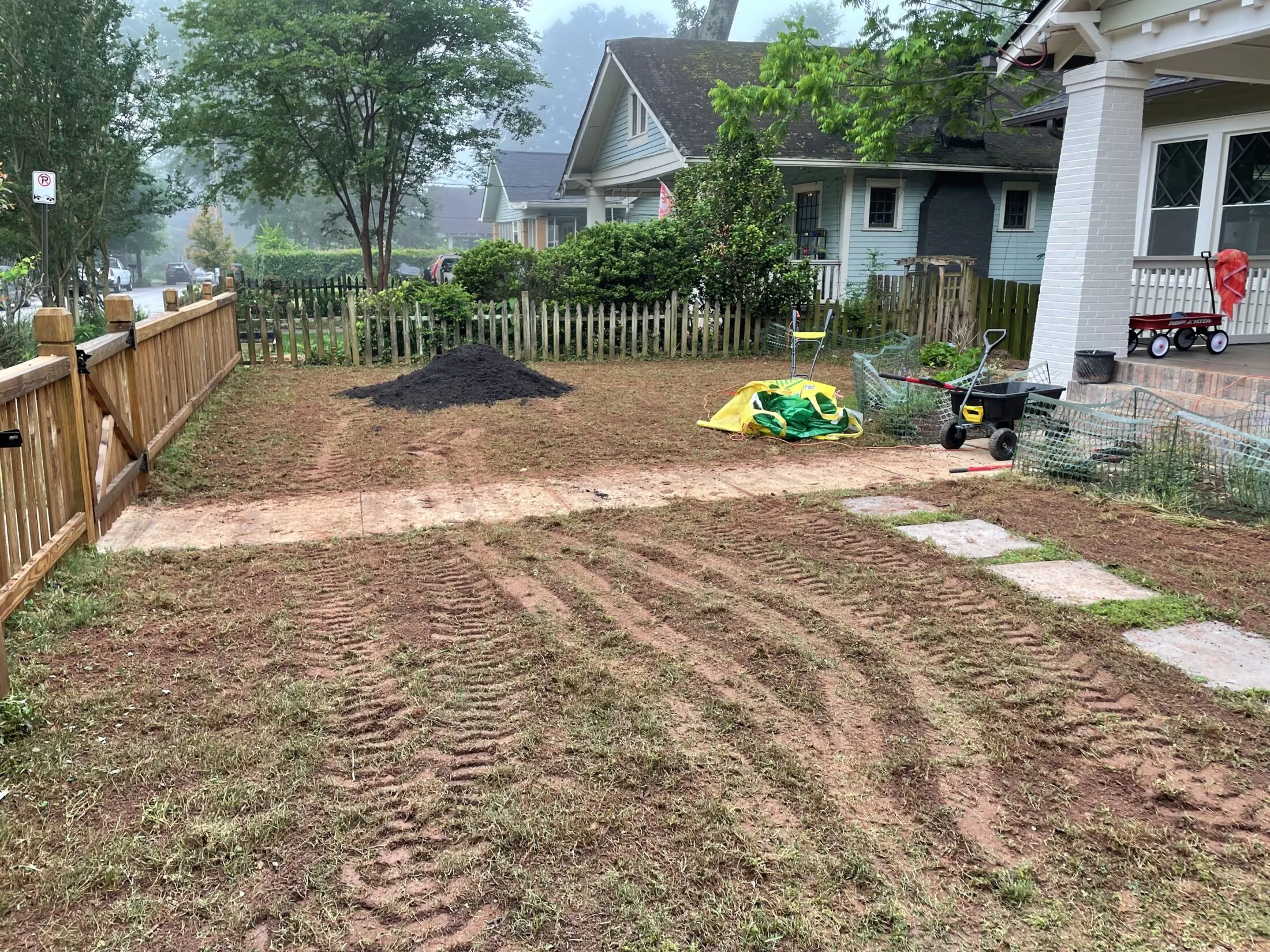 Bag of compost dumped in the yard.