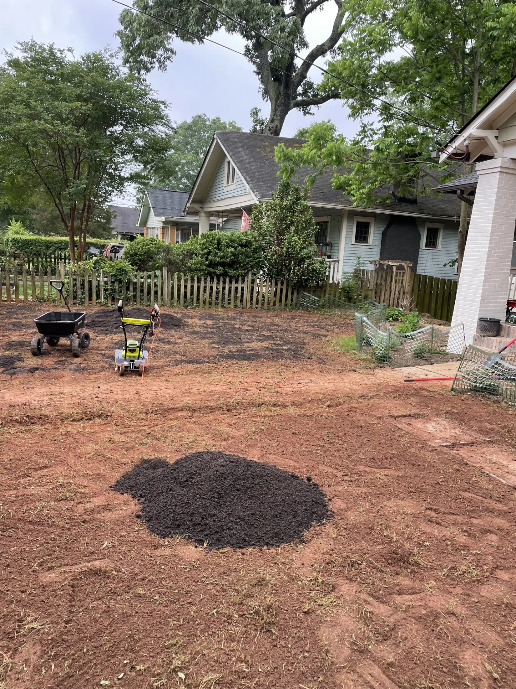 Spreading out the bag of compost.