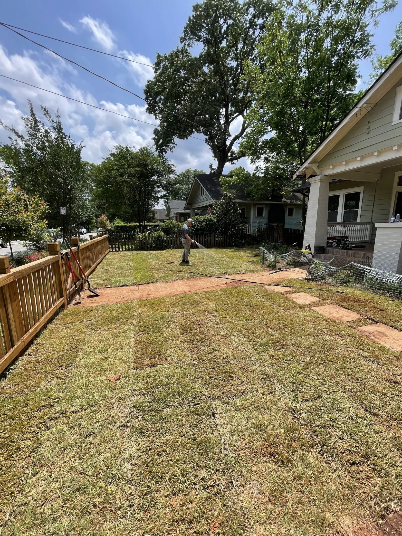 Ramsay watering the sod.