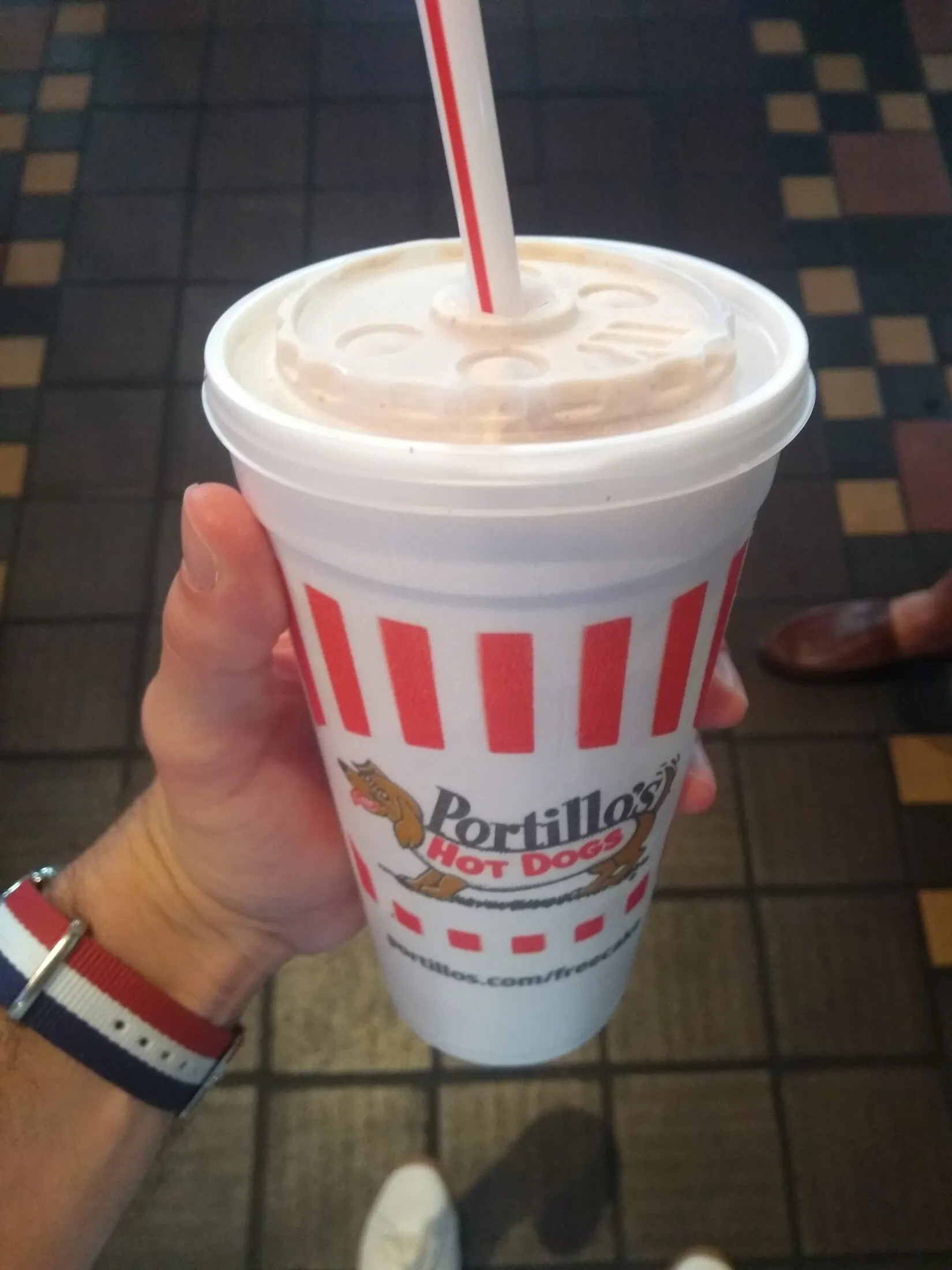 Holding a Portillo's cake shake cup.
